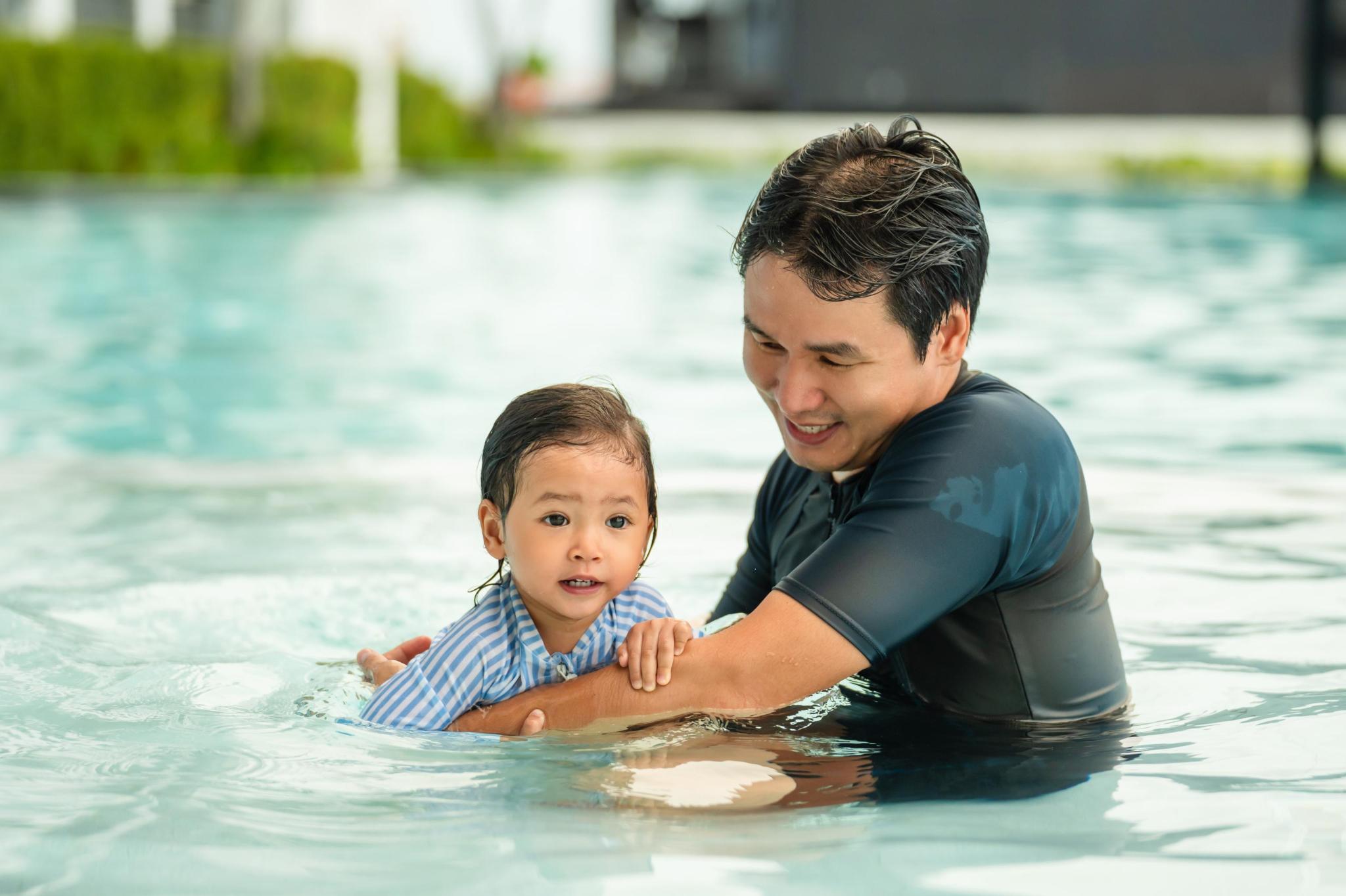 Child and therapist undertaking hydrotherapy session in a pool